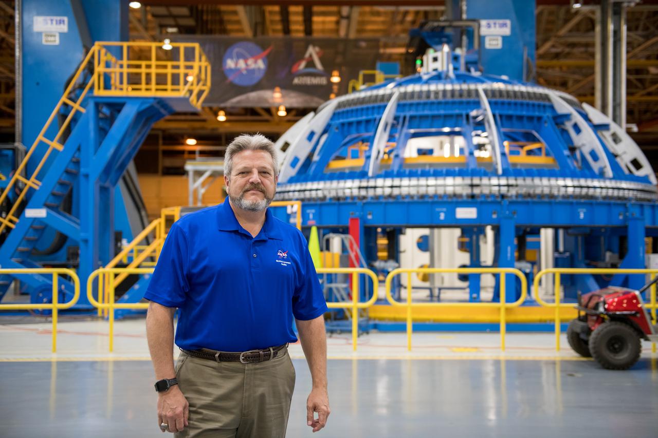Robert Champion - Director NASA Michoud Assembly Facility stands in front of the Robotic Weld tool in BLDG 103.